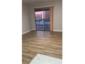 Cozy living room with sliding glass doors that offer great natural light and laminate floors at 5241 River Glen Dr # 184, Las Vegas, NV 89103