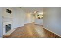 Living room with fireplace and hardwood floors open to the kitchen at 5250 S Rainbow Blvd # 2120, Las Vegas, NV 89118