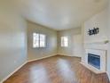 Bright living room showcasing hardwood floors, a cozy fireplace, and natural light at 5250 S Rainbow Blvd # 2120, Las Vegas, NV 89118
