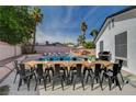 Beautiful backyard featuring a large pool, dining table, and lounge chairs at 7285 Pinebrook Cir, Las Vegas, NV 89147