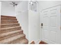 Inviting foyer with a carpeted staircase leading to the upper level of the home at 7873 Marbledoe St, Las Vegas, NV 89149