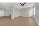 Modern living room with wood-look floors, and neutral gray walls at 8186 Lone Boulder St, Las Vegas, NV 89113