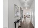 Bright hallway with hardwood floors, designer lighting, and an open view of the living area at 924 Mayfield Manor Ln, Las Vegas, NV 89138