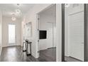 Hallway with wood floors, modern light fixtures, leading to other rooms at 924 Mayfield Manor Ln, Las Vegas, NV 89138