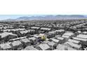 Bird's eye view of a residential community featuring uniform homes against a backdrop of distant mountains at 9527 Havasu Canyon Ave, Las Vegas, NV 89166