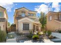 Beautiful two-story home with a well-manicured front yard, complete with desert landscaping and mature trees at 9533 Solitude Canyon Ave, Las Vegas, NV 89149