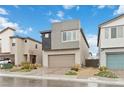 Two-story home with a contemporary exterior, a two-car garage, and a paved driveway, complimented by desert landscaping at 10190 Natural Anchor St, Las Vegas, NV 89166