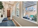 Bright entryway with wood floors, bench seating, and a view of the outdoor patio through large windows at 1049 Via Saint Lucia Pl, Henderson, NV 89011