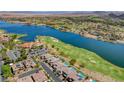 Overhead view of Lake Las Vegas, green fairways, upscale homes, pools, a lake and desert mountains at 116 Juliette Pointe Ln, Henderson, NV 89011