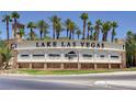 Lake Las Vegas entrance sign surrounded by palm trees under a bright, sunny blue sky at 116 Juliette Pointe Ln, Henderson, NV 89011