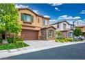 Two-story home with stone accents, tile roof, brown trim, well-manicured lawn, and a two-car garage at 12240 Old Muirfield St, Las Vegas, NV 89141