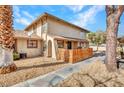 Tan two-story home featuring wooden fence and desert landscaping at 1344 Lorilyn Ave # 3, Las Vegas, NV 89119