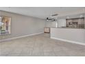 Open-concept living room with tile floors and kitchen access at 1344 Lorilyn Ave # 3, Las Vegas, NV 89119