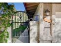 Close-up of a gated courtyard entrance with a brick pathway and exterior lighting at 1905 Calle De Espana, Las Vegas, NV 89102