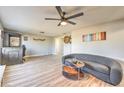 Open-concept living room featuring wood floors and a cozy seating arrangement at 2129 N Michael Way, Las Vegas, NV 89108