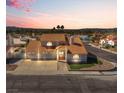 An aerial view of a single-Gathering home with tile roof, three-car garage, and desert landscaping at 2161 Avalon Dr, Laughlin, NV 89029