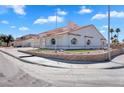 A white single-Gathering home with a tile roof and manicured landscaping at 2161 Avalon Dr, Laughlin, NV 89029