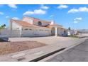 A white single-Gathering home with a tile roof, three-car garage, and desert landscaping at 2161 Avalon Dr, Laughlin, NV 89029