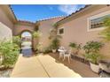 Cozy courtyard features desert landscaping, a small seating area, and stucco walls at 2756 Strathblane Ave, Henderson, NV 89044