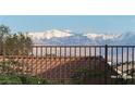 Stunning mountain view behind a decorative tile roof and wrought iron fence at 2764 Leys Burnett Ave, Henderson, NV 89044