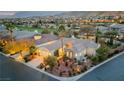 Stunning aerial view of a luxury home with lush landscaping and a golf course in the background at 2785 Soft Horizon Way, Las Vegas, NV 89135