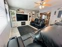 Spacious living room with a fireplace, built-in shelving, and cozy reclining furniture at 3601 Chevy Chase Ave, Las Vegas, NV 89110