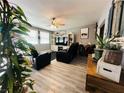 Comfortable living room with plush seating, modern entertainment center, and stylish ceiling fan at 3601 Chevy Chase Ave, Las Vegas, NV 89110