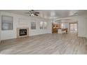 Spacious living room featuring a fireplace, an open floor plan and new wood-look floors at 3932 Maldive Isle Ct, Las Vegas, NV 89129