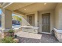 Covered front porch with brick pavers, decorative column bases, and a dark-colored front door at 4813 Stony Hill St, North Las Vegas, NV 89031