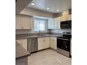 Bright kitchen features stainless steel appliances, white cabinets, and neutral countertops at 5312 W Oakey Blvd, Las Vegas, NV 89146