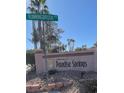 Entrance to Paradise Springs community with Runningbrook Rd sign and lush landscaping at 5366 Runningbrook Rd, Las Vegas, NV 89120