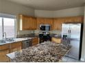 Bright kitchen with wood cabinets, stainless steel appliances, and a granite countertop island at 5758 Yellowcrest Ct, Las Vegas, NV 89113