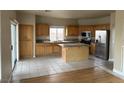 Spacious kitchen featuring wood cabinets, stainless steel appliances, and a large granite island at 5758 Yellowcrest Ct, Las Vegas, NV 89113