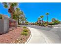 Street view of Kingston community sign with lush landscaping and palm trees at 5952 Long Bay St, Las Vegas, NV 89148