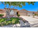 Charming single-story home showcasing a well-manicured front yard and a two car garage at 5952 Long Bay St, Las Vegas, NV 89148