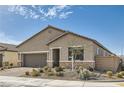 Charming single-story home featuring desert landscaping and a two-car garage at 6033 Bugsy St, North Las Vegas, NV 89081