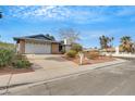 Single-story home with attached garage, mature trees, and desert-style landscaping at 700 Northstar St, Las Vegas, NV 89107