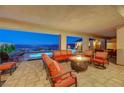 Relax on this covered patio with elegant outdoor furniture and a cozy fire pit, perfect for entertaining at 8 Reverie Heights Ave, Henderson, NV 89011