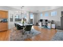 Dining room with wood floors, a modern light fixture, and a workstation at 8036 Eurostar St, Las Vegas, NV 89131