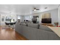 Open concept living room featuring wood floors, a fireplace, and neutral paint at 8036 Eurostar St, Las Vegas, NV 89131