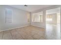 Open living room featuring tile floors, neutral walls, and large windows for natural light at 8045 Sundance Valley Dr, Las Vegas, NV 89178