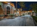 A long private driveway leads to a luxury home with a grand entrance and stone accents at 8280 Via Olivero Ave, Las Vegas, NV 89117