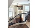 View of the landing with windows and railings overlooking the living area with a piano and staircase at 8426 Sluman Ct, Las Vegas, NV 89128