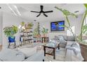 Cozy living room with a comfortable gray sectional, stylish decor, and lush indoor plants at 10415 Scarpa St, Las Vegas, NV 89178