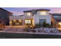 Contemporary two-story home with a modern garage door and professionally landscaped front yard at 12160 Harris Summit Ave, Las Vegas, NV 89138