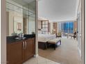 Bedroom with large windows offering city views, along with a bar and seating area at 125 E Harmon Ave # 809, Las Vegas, NV 89109