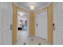 Hallway with doors leading to rooms, featuring tile flooring and neutral wall colors at 125 E Harmon Ave # 809, Las Vegas, NV 89109