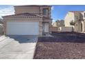 Inviting two-story home with a two-car garage and desert landscaping at 1331 Ebbetts Pass, Las Vegas, NV 89110