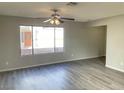 Bright living room featuring stylish wood flooring and a large window at 1331 Ebbetts Pass, Las Vegas, NV 89110