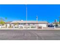 Single-story home featuring a spacious front yard with a long driveway and fenced yard at 1805 Ivanhoe Way, Las Vegas, NV 89102